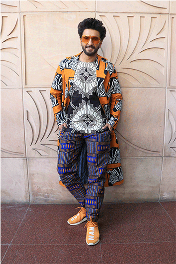 Fashionable Man Posing Against Decorative Wall