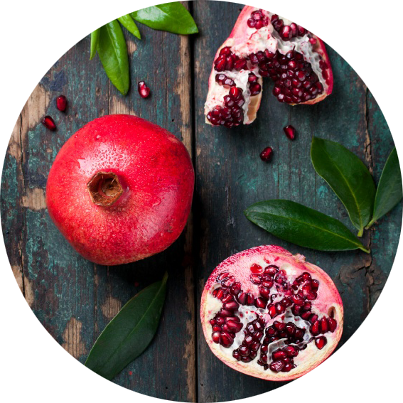 Fresh Pomegranateand Seedson Wooden Background