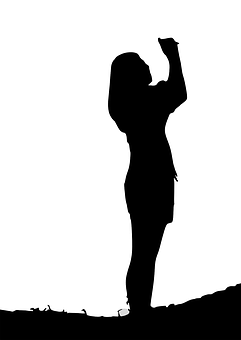 Silhouetteof Woman Raising Hand