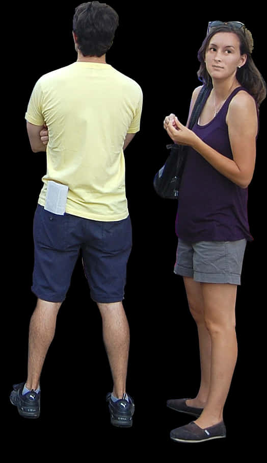Two People Standing Against Black Background