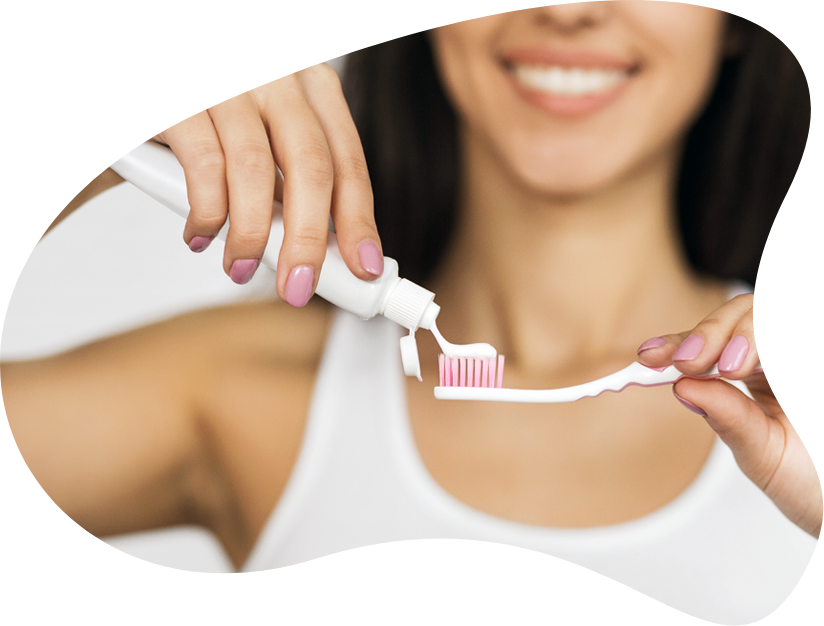Woman_ Applying_ Toothpaste_ On_ Toothbrush
