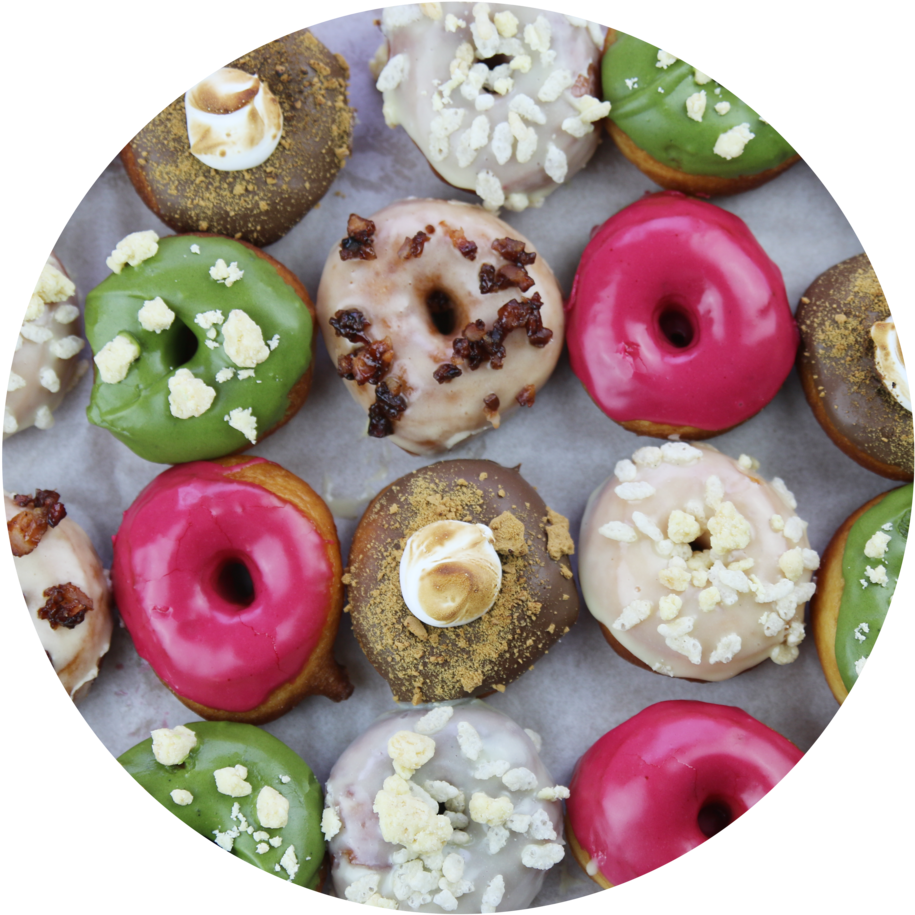 Assorted Gourmet Doughnuts Top View PNG image