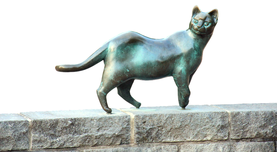Bronze Cat Sculpture Stone Ledge PNG image
