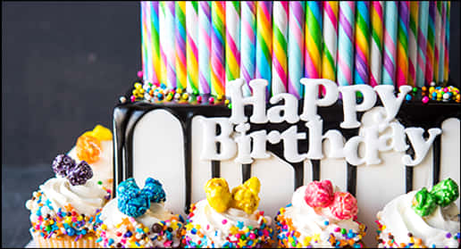 Colorful Birthday Cakewith Cupcakesand Candles PNG image