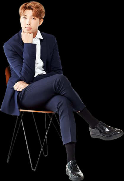 Elegant Man Seatedin Blue Suit PNG image