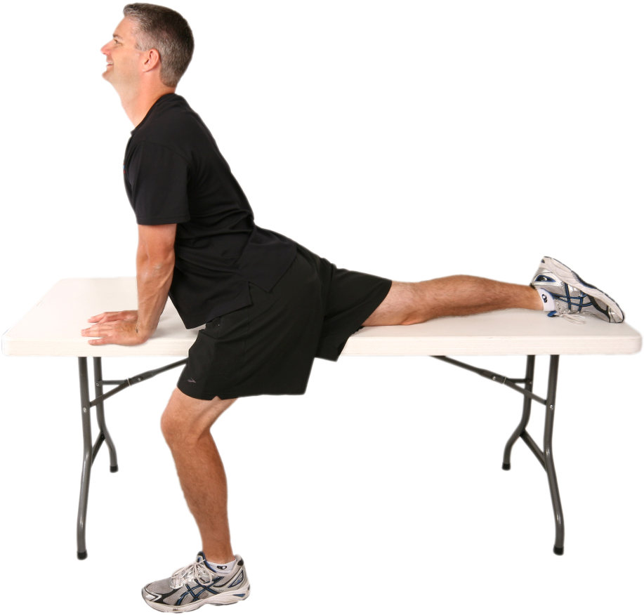 Man Performing Hip Flexor Stretchon Table PNG image