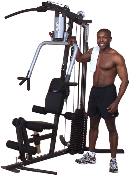 Man Smiling Beside Multi Gym Equipment PNG image