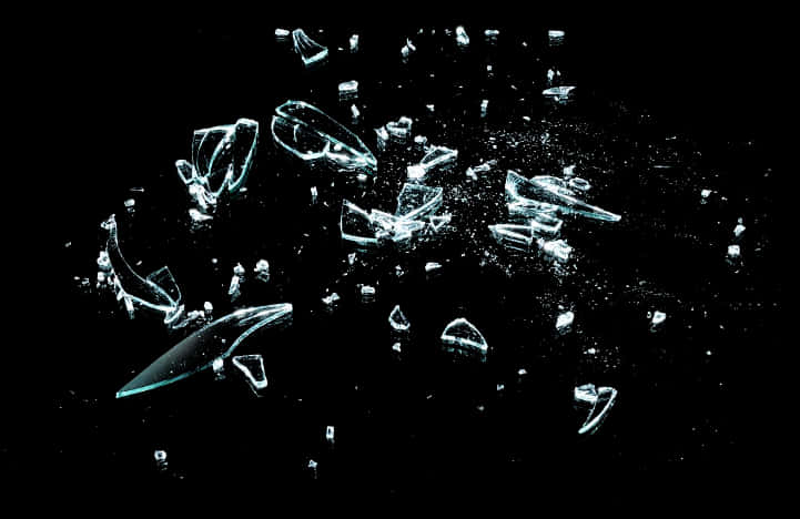 Shattered Glass Fragments Against Black Background PNG image