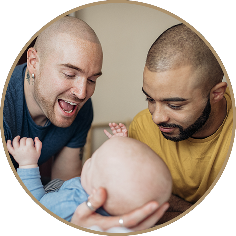 Two Men Admiring Baby PNG image