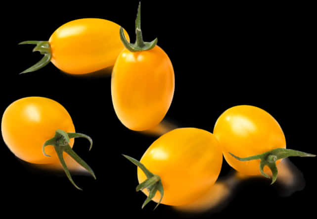 Yellow Cherry Tomatoeson Black Background PNG image