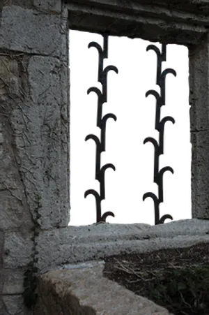Ancient Stone Windowwith Iron Bars PNG image