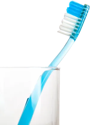 Blue Toothbrush Leaningon Glass PNG