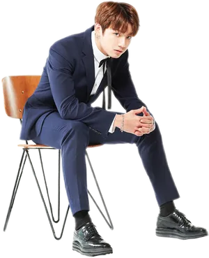 Elegant Man Seatedin Blue Suit PNG image