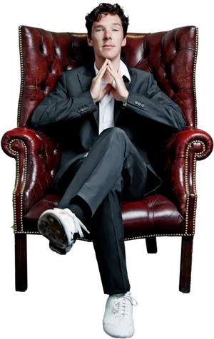 Elegant Man Seatedin Red Leather Chair PNG image