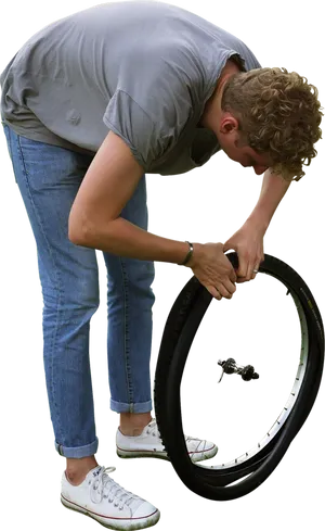 Man Repairing Bicycle Tire PNG