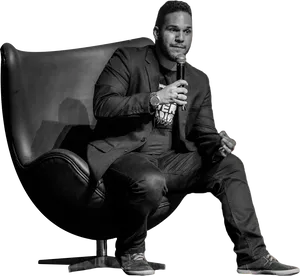 Man Sittingin Chair Speaking PNG image