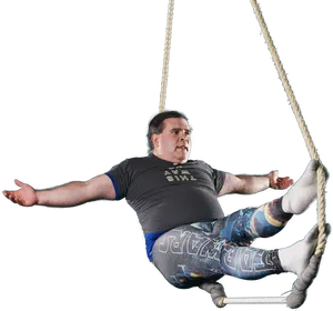 Man Swingingon Rope PNG image