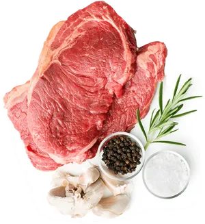 Raw Steakwith Herbsand Spices PNG image