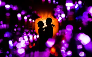 Silhouette Love Amidst Shimmering Lights PNG image