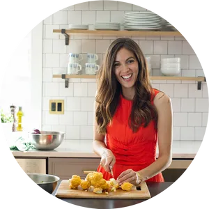 Smiling Woman Cookingin Kitchen PNG image