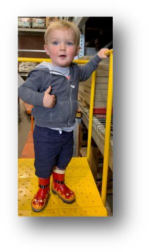 Toddler In Warehouse With Boots
