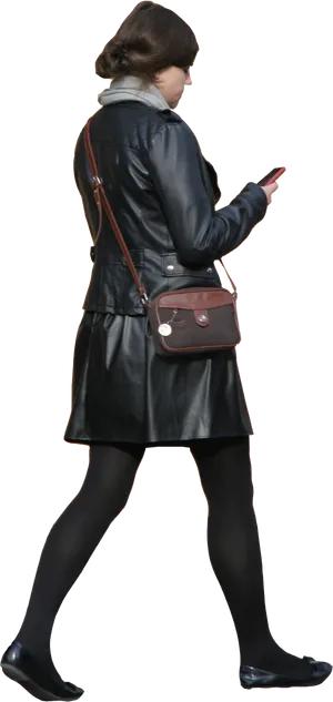 Womanin Leather Coat Walkingand Texting PNG