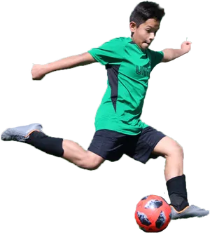 Youth Soccer Player Kicking Ball PNG image